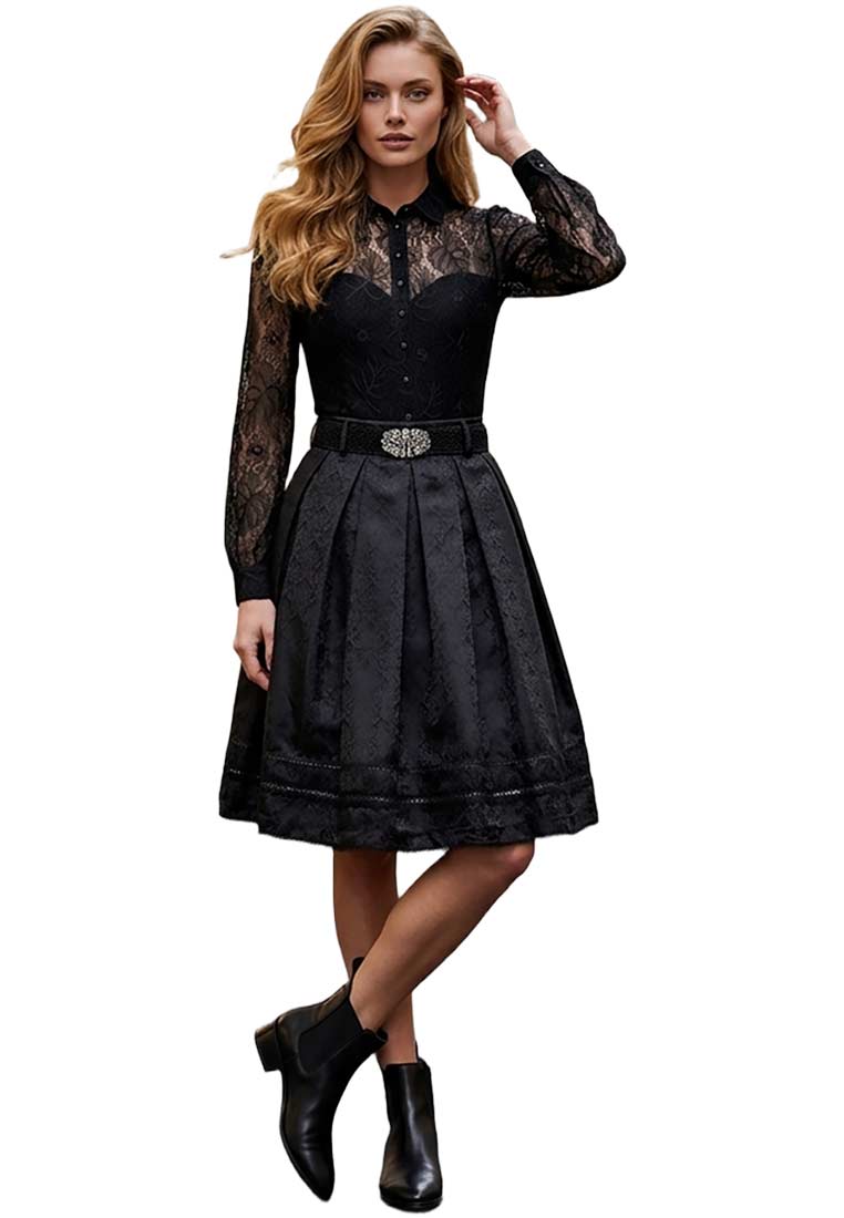 Marjo Trachtenrock Eleana in Schwarz, vorne im Bild mit schwingendem Rockteil und Gürtel, mit Faltenlegung und Besatz am Saum.