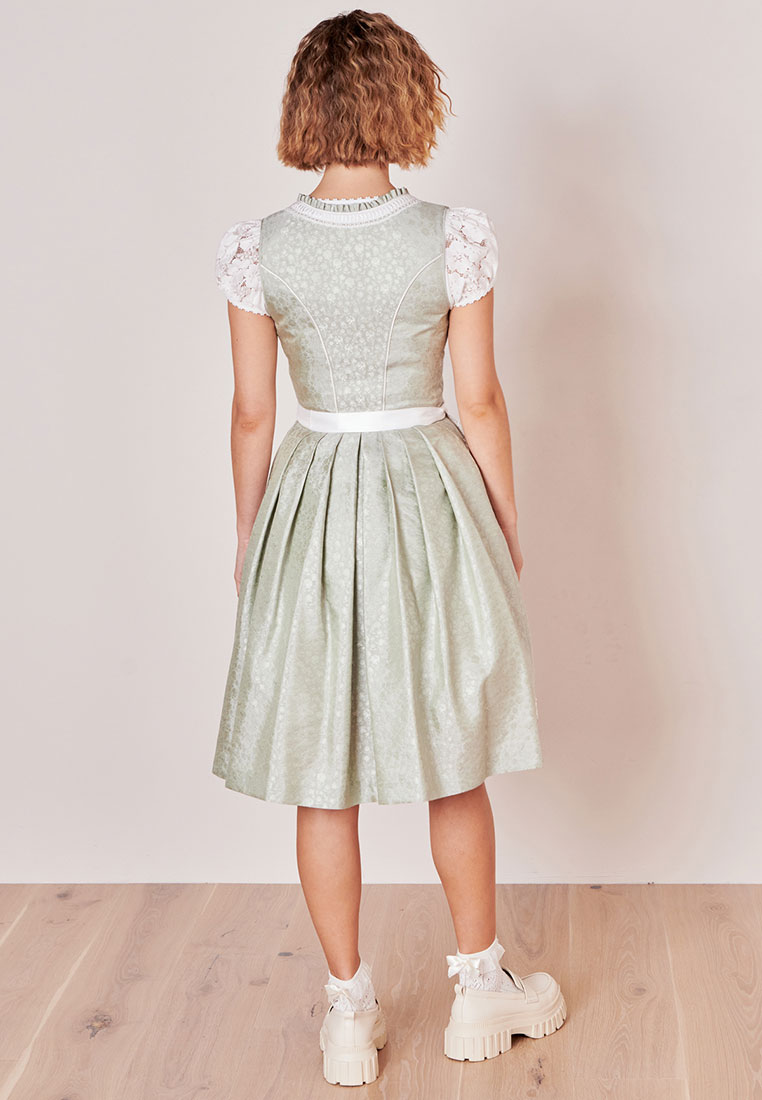 Rückansicht des Dirndls Zephyra von Krüger in Hellgrün, mit weißem Satinband und einem dezenten Muster.