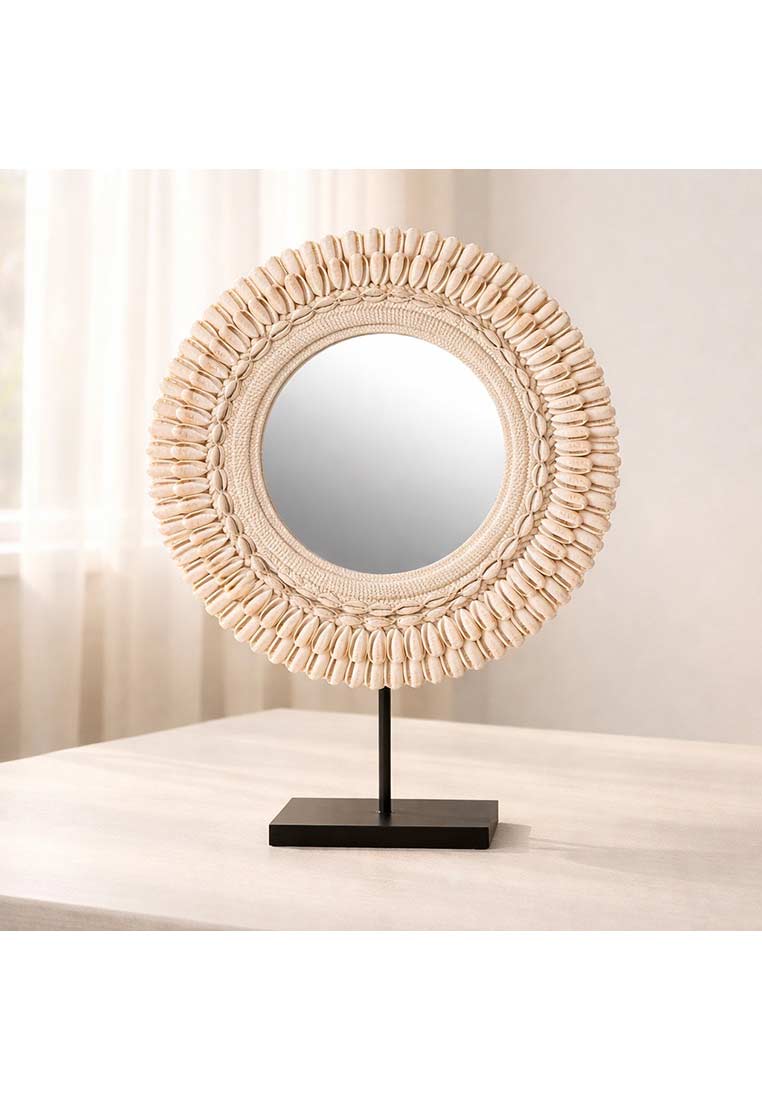 J-LINE Standspiegel Muscheln Mona, Frontansicht, creme-farben. Der runde Spiegel ist mit Muscheln verziert und steht auf einem dunklen rechteckigen Fuss.