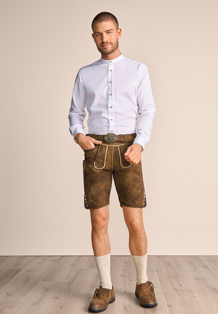 Frontansicht eines Mannes im weißen Krüger Trachtenhemd Niko mit Stehkragen und silbernen Knöpfen, kombiniert mit brauner Lederhose.