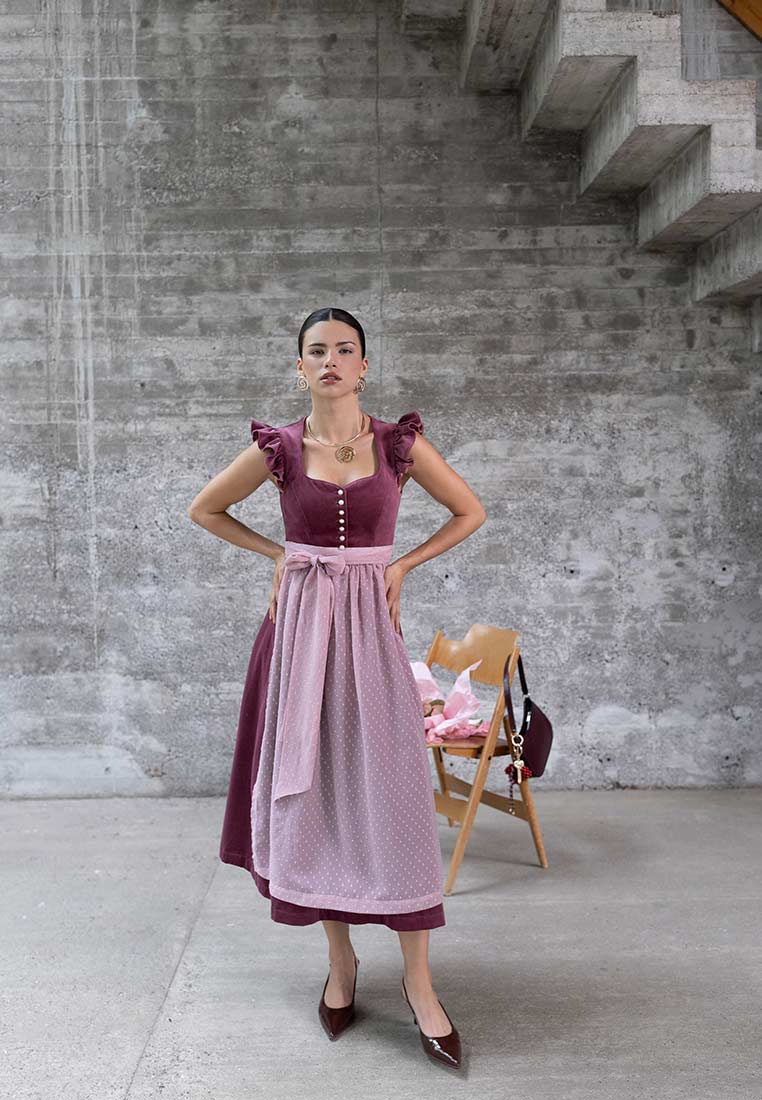 Madame Marie Dirndl Soralyn Samt pflaume (borderaux) 65 cm in Frontansicht, mit einem Samt-Oberteil und einer gemusterten Schürze.