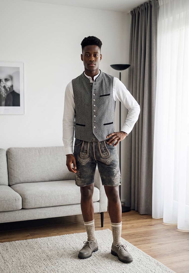 Maddox Lederhose Kienberg kiesel in Grautönen, vorne sitzend, mit sichtbarer Stickerei und seitlichen Gürtelschlaufen.