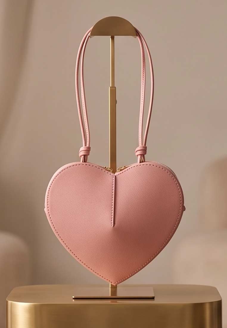PAN Lederwaren Trachtentasche Herzblatt rosa, Frontansicht der stilvollen herzförmigen Tasche mit Lederhenkeln und sichtbarem Reissverschluss.