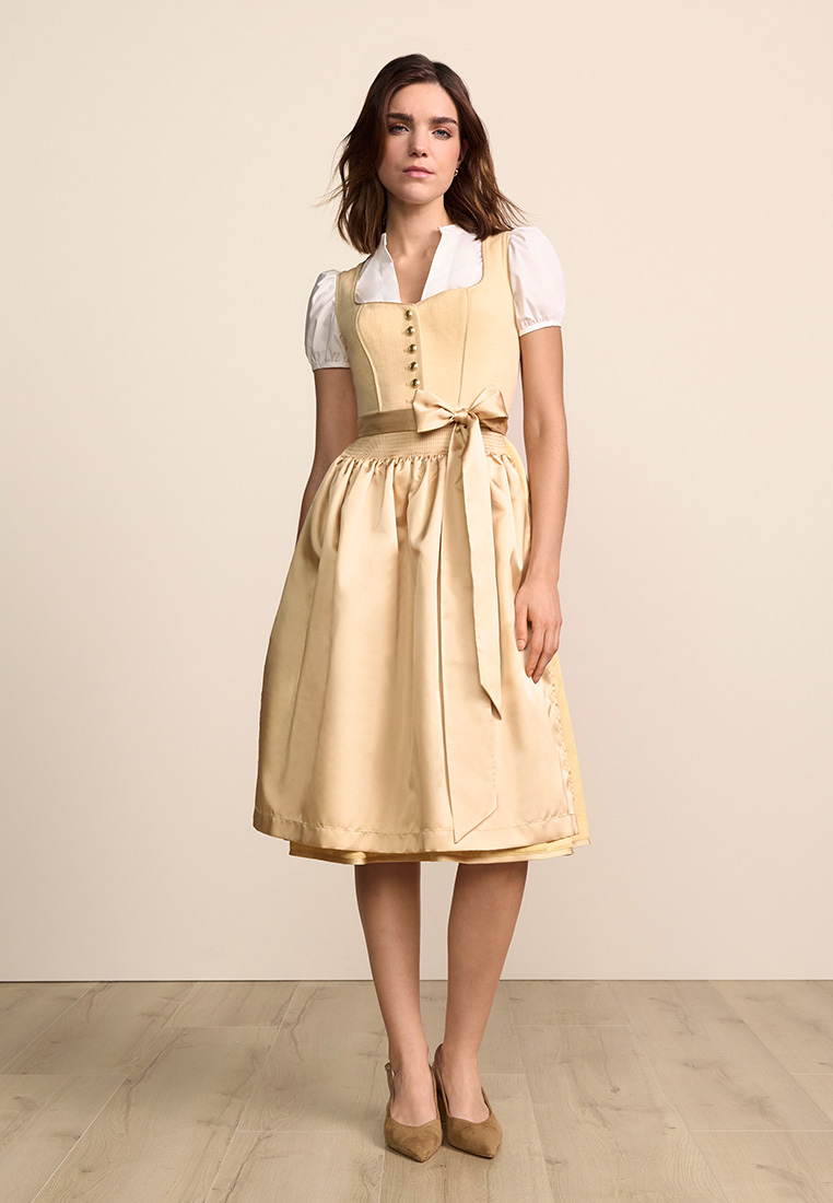 Krüger Dirndl Miralys gelb 70cm in Frontansicht mit sichtbarer Schnürung und gebundener Schürze.